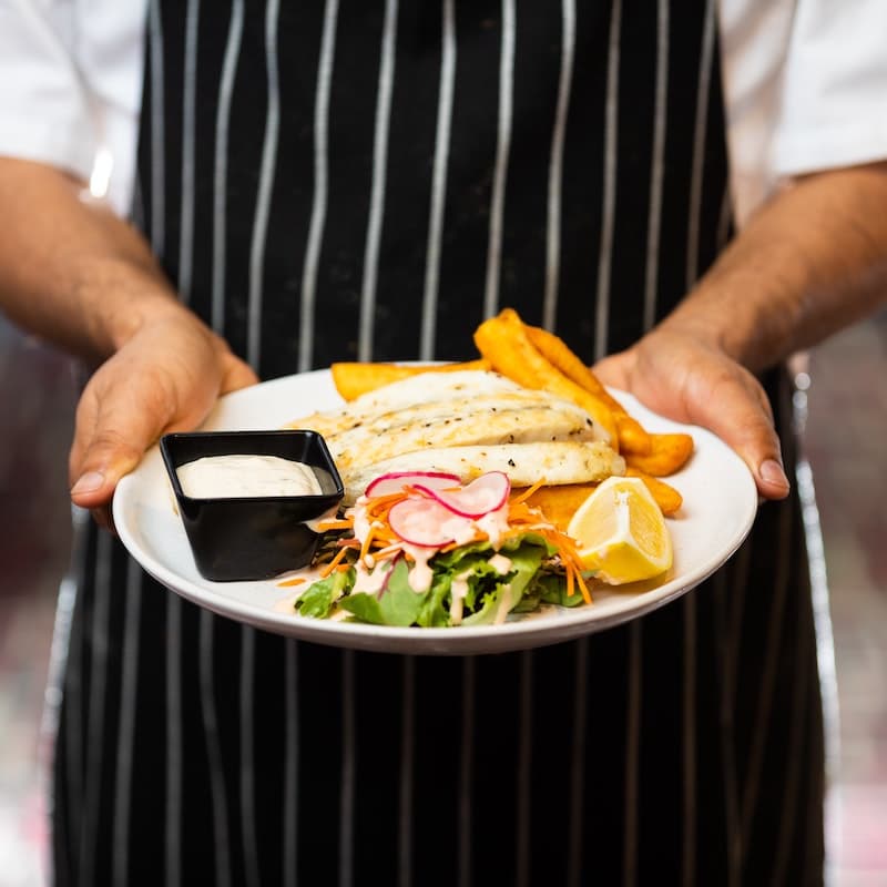 chef presenting beautifully plated meal